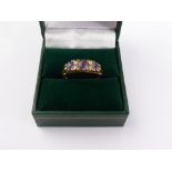 A Lady's 18 ct Gold Carved Head Amethyst and Diamond Ring. Centre Ame 5 mm, 2 x 3 mm outside, 4 x