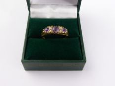 A Lady's 18 ct Gold Carved Head Amethyst and Diamond Ring. Centre Ame 5 mm, 2 x 3 mm outside, 4 x