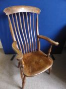 An antique oak Windsor armchair being spindle  backed.