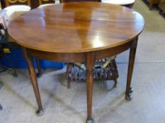 An Oval Mahogany Dining Table, on turned legs with pad feet, with leaf, est 112 x 164 x 74 cms.