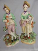 A Pair of Staffordshire Style Figures depicting a Shepherd and Shepherdess, each one carrying a