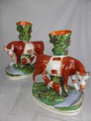 A Pair of 19th Century Staffordshire Spill Vases, depicting a cow and her calf beside a stream,