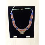 A Lady's Silver and Semi-Precious Stone Necklace, the necklace set with Lapis, Coral and Turquoise.