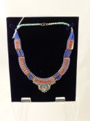 A Lady's Silver and Semi-Precious Stone Necklace, the necklace set with Lapis, Coral and Turquoise.