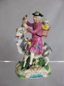 A 19th Century Porcelain Figure of Von Bruhl tailor, believed to be Rockingham, astride a goat,