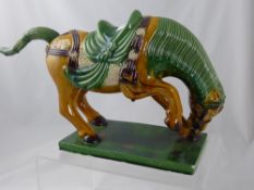 A Chinese Tang Style Pottery Horse, with high glaze, 24 cms h
