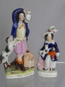 Two Staffordshire Figures, depicting characters with their dogs. The first figure measures est