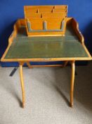 An Edwardian oak campaign writing desk with green leather insert and a stationery holder.