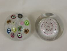 Two Glass Paperweights, Millefiori in style, one with white latticino ribbon with spaced colourful