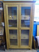 A Contemporary Oak Glazed Display Cabinet, with two internal shelves and four drawers, est 108 x