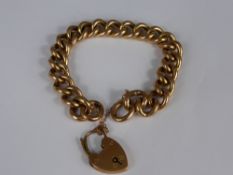 A lady's 9 ct rose gold linked bracelet being hallmarked with safety chain and heart shaped clasp,