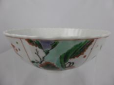 A circa 19th century Chinese famille vert bowl, having a wavy rim with segmented sections with