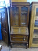 An Edwardian Dark Oak Bureau Bookcase, leaded lights to the top, pigeon holes to the interior with a