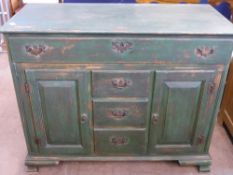 A Green Painted Pine Dresser Base, having one long drawer with three drawers to the centre below and