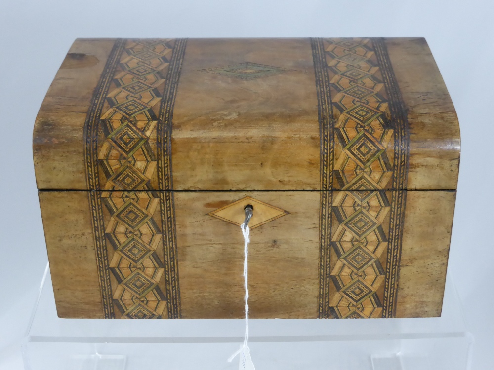 A vintage wooden sewing box, decorated with inlaid banding and central cartouche, containing some