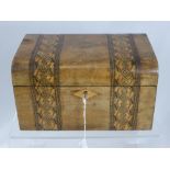 A vintage wooden sewing box, decorated with inlaid banding and central cartouche, containing some