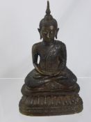 A circa 19th century bronze Sino Tibetan figure of Buddha, the figure in a lotus position with