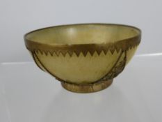 A Chinese jade style bowl with pierced metal surrounds decorated with dragons, est. height 5 cms.