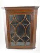 A small mahogany corner cabinet having two shelves and an astral glazed door, est. 45 x 24 x 56