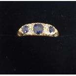 A lady's 18 ct gold diamond and sapphire ring. 4 x old cut dias. 2.5 pts each, centre saph 5.3 x 4.2