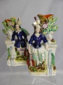 A Pair of Staffordshire Spill Vases, depicting two musicians beside a fountain, est height 19.5