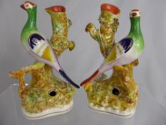 A Pair of Staffordshire Spill Vases, depicting a seated bird on a naturalistic vase, est height 17