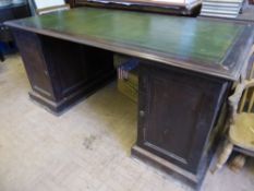 An Edwardian mahogany twin pedestal desk having green embossed leather to top, the pedestals