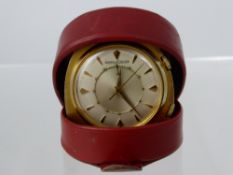 A Jaeger Le Coutre vintage travel alarm clock, bevel number to reverse 828328, in the original red