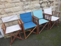 Four teak and canvas folding garden chairs.