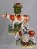 A 19th Century Staffordshire Spill Vase, depicting a cow and dairy maid est 27 cms together with a