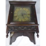An Antique Brass Face Longcase Clock Movement, with oak wall case and sun face pendulum.