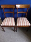 Three Victorian mahogany dining chairs being bar backed with turned front legs, the seats being