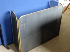 A brass and wire mesh fire guard having hinged side pieces, est. 96 x 38 x 76 cms.