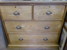 An Antique Oak Chest of Drawers, with two long and two short drawers with shell effect handles on