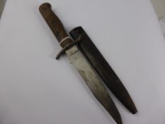A Vintage Wooden Handle Continental Style Bowie Knife in metal sheath. The blade hilt engraved