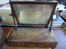 A Georgian Mahogany Toilet Mirror, with three drawers and turned supports on bun feet.