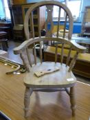 An Antique Child's Oak Windsor Splat and Spindle Back Armchair.