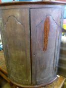 An antique bow fronted mahogany corner cupboard having two shelves to the interior, est. 67 x 47 x