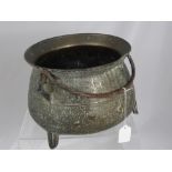 An Antique Bronze Cauldron, tri-footed with a handle, est 32 cms including the handle mounts and the