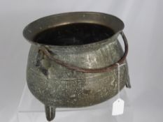 An Antique Bronze Cauldron, tri-footed with a handle, est 32 cms including the handle mounts and the