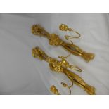 A pair of gilt and plaster wall hanging two branch candle sconces having tassel, fruit and flower