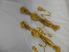 A pair of gilt and plaster wall hanging two branch candle sconces having tassel, fruit and flower