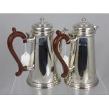 A Solid Silver Coffee and Water Jug. The tankard style pots having corn finials, London