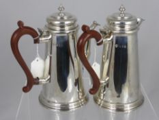 A Solid Silver Coffee and Water Jug. The tankard style pots having corn finials, London