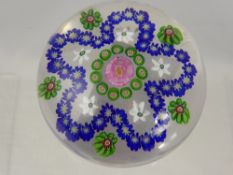 An Antique French Clichy Glass Paperweight, with central rose and a blue floral surround highlighted