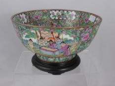 A Cantonese Famille Rose Bowl, the interior painted with figurines in a courtyard, at the outer