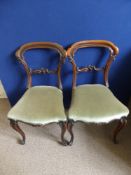 Three Victorian bar back dining chairs, the centre bar having carved decoration on cabriole legs,