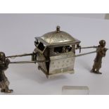 An Antique Chinese Silver Study of Two Figures, carrying a sedan chair, character marks to base.