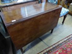 A mahogany drop leaf dining table on tapered legs, est. 98 x 131 x 70 cms.