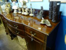 An Edwardian mahogany pedestal sideboard, the centre bow section having two drawers, each pedestal